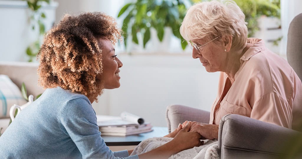 CAREgiver helping senior woman maintain her independence by supporting her at home