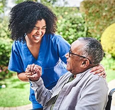 EMPOWERING FAMILIES WITH COMPREHENSIVE IN-HOME CARE 12 SMILING CAREGIVER AND SENIOR MAN IN WHEELCHAIR